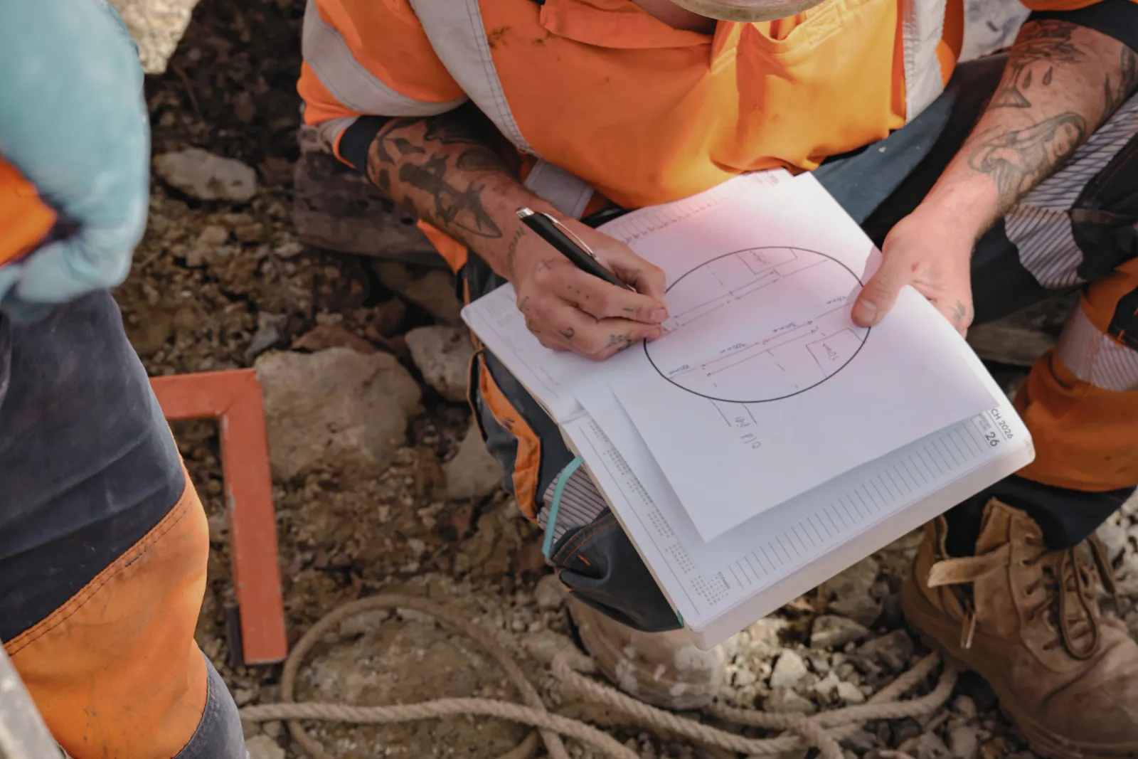 Site engineer checking plans and quality records on site.