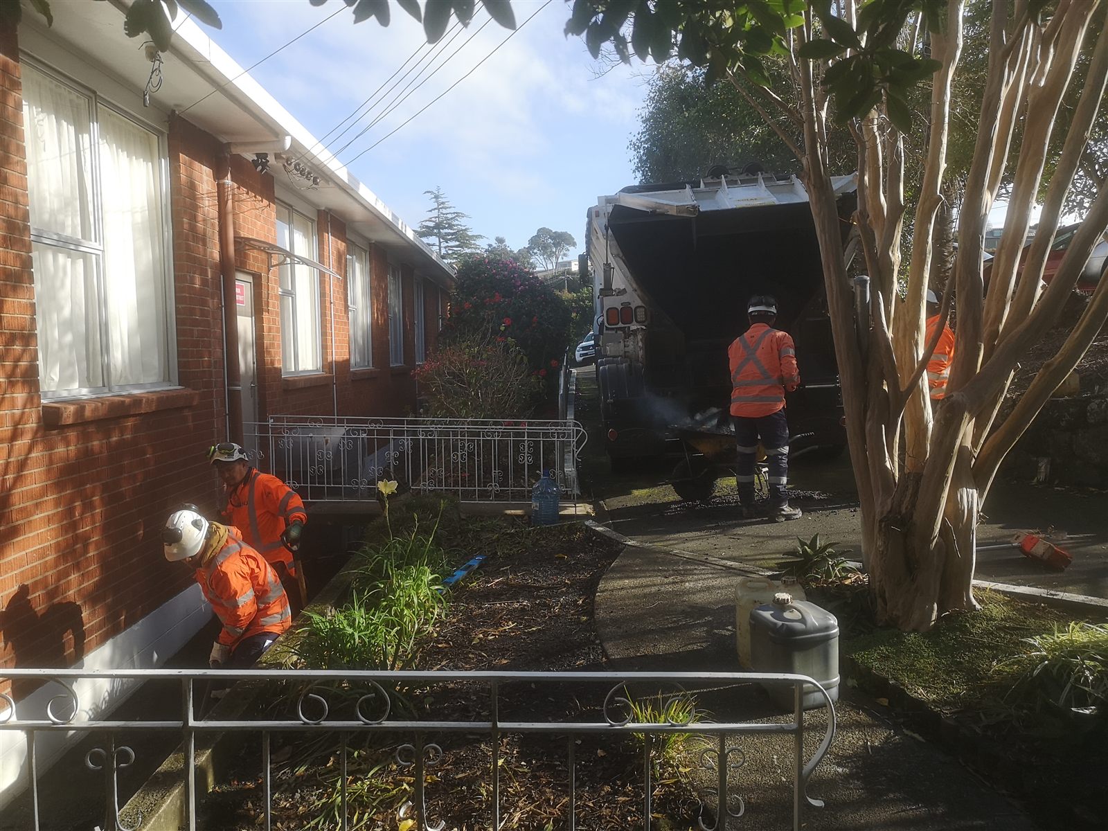 Livic crew carrying out drainage work beside an East Coast Bays property.