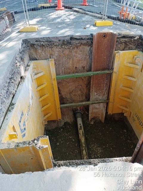 Shored trench with bedding prepared for stormwater pipework.
