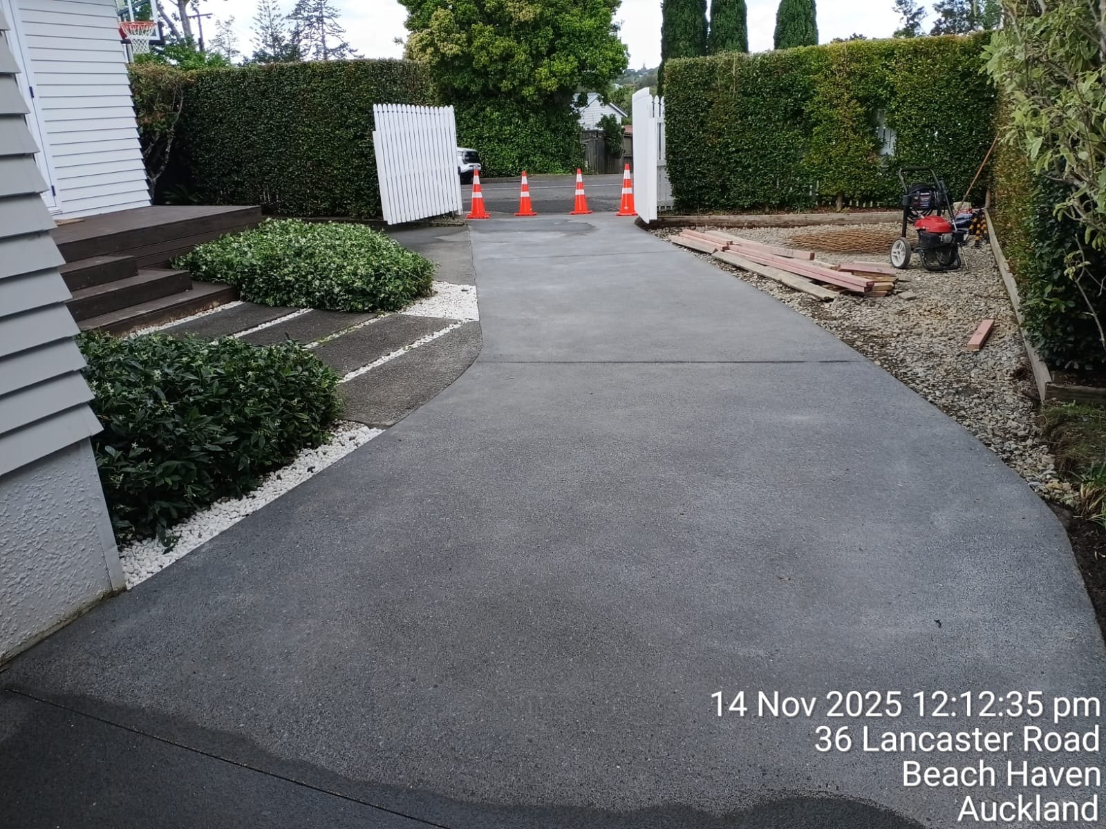 New concrete driveway surface running from the property toward the street.