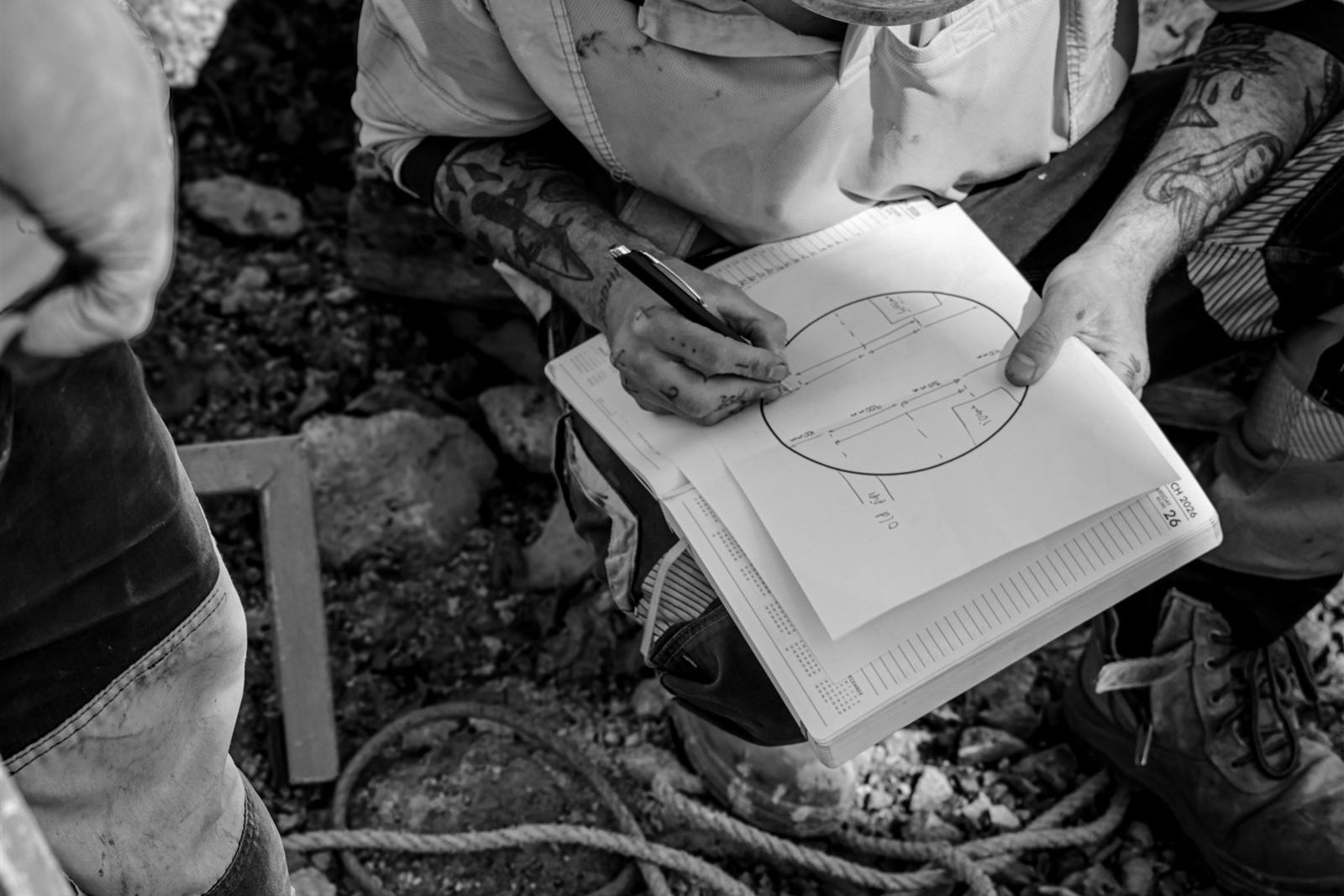 Site engineer checking plans and quality records on site.