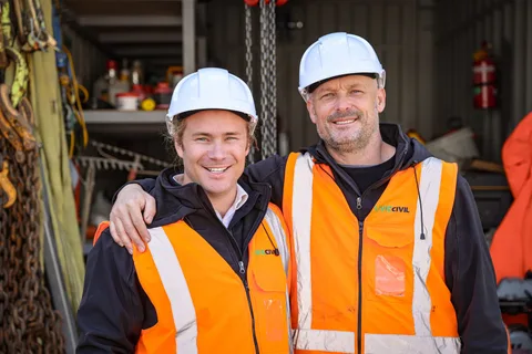 Two Livic Civil team members in safety gear at a work area.