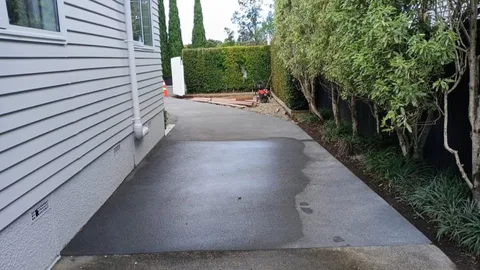 Completed concrete driveway beside a residential house in Beach Haven.