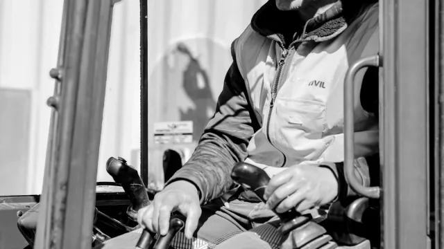 Livic Civil team member at the controls inside an excavator cab