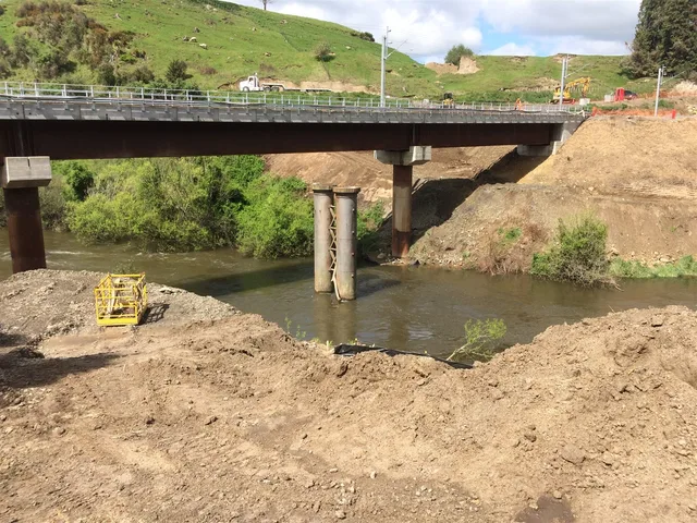 Bridge and retaining structure civil works over a stream.